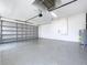 A spacious garage features epoxy floors, an automatic door opener, and a hot water heater at 9065 Mississippi Run, Weeki Wachee, FL 34613