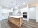 Spacious kitchen with a large island, stainless steel appliances, and modern pendant lighting at 9065 Mississippi Run, Weeki Wachee, FL 34613