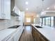 A modern kitchen with stainless appliances, granite countertops, pendant lights and eat-in island at 9065 Mississippi Run, Weeki Wachee, FL 34613