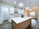 Spacious kitchen features a central island, stainless steel appliances, and pantry at 9065 Mississippi Run, Weeki Wachee, FL 34613