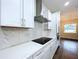 Modern kitchen with sleek countertops, backsplash, stainless steel hood, and built-in appliances at 9065 Mississippi Run, Weeki Wachee, FL 34613