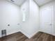 Unfurnished laundry room with new wood floors, utility sink and a door to the backyard at 9065 Mississippi Run, Weeki Wachee, FL 34613