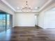 Open living space featuring a large sliding glass door with hardwood floors at 9065 Mississippi Run, Weeki Wachee, FL 34613
