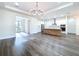 Spacious living room with an open layout that connects to the kitchen and dining area at 9065 Mississippi Run, Weeki Wachee, FL 34613