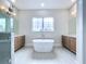 Contemporary bathroom featuring a standalone tub, dual sinks, and stylish fixtures at 9065 Mississippi Run, Weeki Wachee, FL 34613