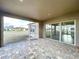 A covered and screened patio featuring brick floors and a view of the backyard at 9065 Mississippi Run, Weeki Wachee, FL 34613