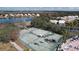 Community tennis courts overlooking tranquil pond and neighborhood homes at 9065 Mississippi Run, Weeki Wachee, FL 34613