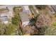 Aerial view of the property featuring a fenced yard and gravel driveway at 9250 Peony St, New Port Richey, FL 34654
