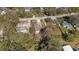 An aerial view of the property reveals a fenced yard, gravel driveway, and cozy home in the neighborhood at 9250 Peony St, New Port Richey, FL 34654