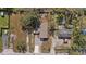Overhead view of the property featuring a fenced yard, gravel driveway, and cozy home at 9250 Peony St, New Port Richey, FL 34654