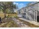 Exterior backyard view with a stone pathway, shed, and wooden fence at 9250 Peony St, New Port Richey, FL 34654