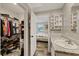 Ensuite bathroom view including the walk in closet, sink with granite top and the bedroom beyond at 9250 Peony St, New Port Richey, FL 34654