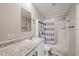 Bathroom features a shower, toilet, vanity, and great lighting at 9250 Peony St, New Port Richey, FL 34654