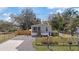 Charming home featuring a cozy front porch, a gravel driveway and a newly installed wooden fence at 9250 Peony St, New Port Richey, FL 34654