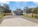 Charming single-story home with a gravel driveway, front porch, and well-maintained lawn at 9250 Peony St, New Port Richey, FL 34654