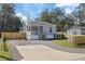 This charming home features a cozy front porch, a concrete driveway and a newly installed wooden fence at 9250 Peony St, New Port Richey, FL 34654