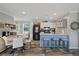 Eat-in kitchen with an island, modern appliances, and wooden-look floors at 9250 Peony St, New Port Richey, FL 34654