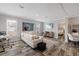 Cozy living room with a modern fireplace and view into the bedroom at 9250 Peony St, New Port Richey, FL 34654