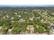 Panoramic aerial view of the neighborhood featuring mature trees, a golf course, and a glimpse of Clearwater Harbor at 1101 N Betty Ln, Clearwater, FL 33755