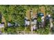 Aerial view showcasing the home's backyard pool and patio, with lush greenery and mature trees at 1101 N Betty Ln, Clearwater, FL 33755