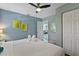 Comfortable bedroom featuring a ceiling fan, closet and a view into the living area at 1101 N Betty Ln, Clearwater, FL 33755