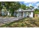 Charming single-story home with a red front door, light blue paint, stone trim, and a well-manicured lawn at 1101 N Betty Ln, Clearwater, FL 33755