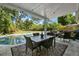 Inviting covered patio with a dining area and a beautiful view of the sparkling swimming pool at 1101 N Betty Ln, Clearwater, FL 33755
