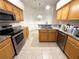 This is a kitchen featuring wood cabinets, granite countertops, and stainless steel appliances at 11204 Clear Oak Cir, New Port Richey, FL 34654