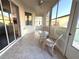 Enclosed sunroom featuring tiled flooring, white wicker furniture, and ample windows allowing natural light at 11204 Clear Oak Cir, New Port Richey, FL 34654