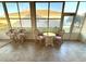 Relaxing enclosed patio area featuring tile floor and lots of sunlight and natural wicker furniture set at 11204 Clear Oak Cir, New Port Richey, FL 34654