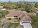 Aerial view of the home and its surrounding treed landscape in the community at 1358 Newhope Rd, Spring Hill, FL 34606
