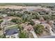 Aerial view of the home and neighborhood in a treed landscape at 1358 Newhope Rd, Spring Hill, FL 34606