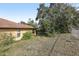 Backyard view shows a flat yard, chain link fence and a portion of the side exterior at 1358 Newhope Rd, Spring Hill, FL 34606