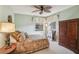 Comfortable bedroom with soft, muted colors, offering a tranquil retreat with a bed and classic wooden armoire at 1358 Newhope Rd, Spring Hill, FL 34606