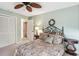 Inviting bedroom with light green walls, a decorative wreath, and a comfortable bed, creating a relaxing atmosphere at 1358 Newhope Rd, Spring Hill, FL 34606
