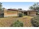 Single story home with stucco exterior, flat yard, and dark colored architectural shingle roof at 1358 Newhope Rd, Spring Hill, FL 34606