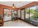 Enclosed sunroom with tiled floor and large windows, offering an excellent space for leisure or indoor activities at 1358 Newhope Rd, Spring Hill, FL 34606