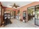 Spacious sunroom with tiled flooring, equipped with a treadmill, shelving, and a view into other rooms at 1358 Newhope Rd, Spring Hill, FL 34606