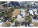 Aerial view of a waterfront property featuring a single-Gathering home, docks, and surrounded by mature trees at 14824 Capri Ln, Hudson, FL 34667