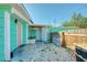 Exterior shot of home backyard with aqua paint, a privacy fence, gravel ground cover, and gated entrance at 14824 Capri Ln, Hudson, FL 34667