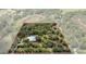 Aerial view of the expansive property featuring a home, pool, and wooded land at 16411 County Road 675, Parrish, FL 34219