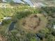 An aerial view of a wooded homesite with water features, offering a private and natural setting at 16411 County Road 675, Parrish, FL 34219
