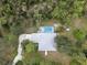A birds-eye view of a light-colored home and driveway, with a backyard screened-in pool area at 16411 County Road 675, Parrish, FL 34219