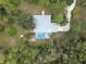 A birds-eye view of a light-colored home and driveway, with a backyard screened-in pool area at 16411 County Road 675, Parrish, FL 34219