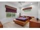 Comfortable bedroom with a large window offering natural light and a custom platform bed at 16411 County Road 675, Parrish, FL 34219