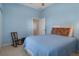 Comfortable bedroom featuring a cozy rocking chair and bright blue walls at 16411 County Road 675, Parrish, FL 34219