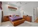 Cozy bedroom featuring a neutral carpet, platform bed, and two windows offering natural light at 16411 County Road 675, Parrish, FL 34219