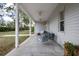 Covered porch with ceiling fans and outdoor seating at 16411 County Road 675, Parrish, FL 34219