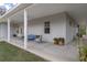 Spacious covered porch with ceiling fan and outdoor seating area at 16411 County Road 675, Parrish, FL 34219