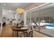 Open-concept dining room and kitchen with a view of the pool area through sliding glass doors at 16411 County Road 675, Parrish, FL 34219